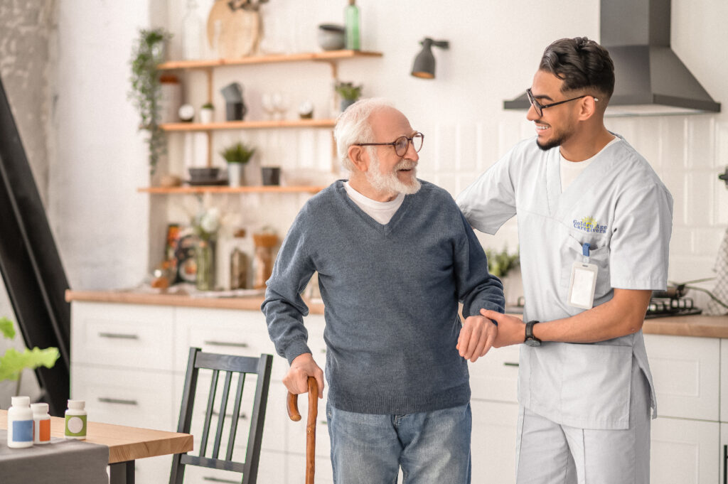 Medical,Worker,Helping,His,Patient,To,Move,Around,The,Apartment | Golden Age Caregivers